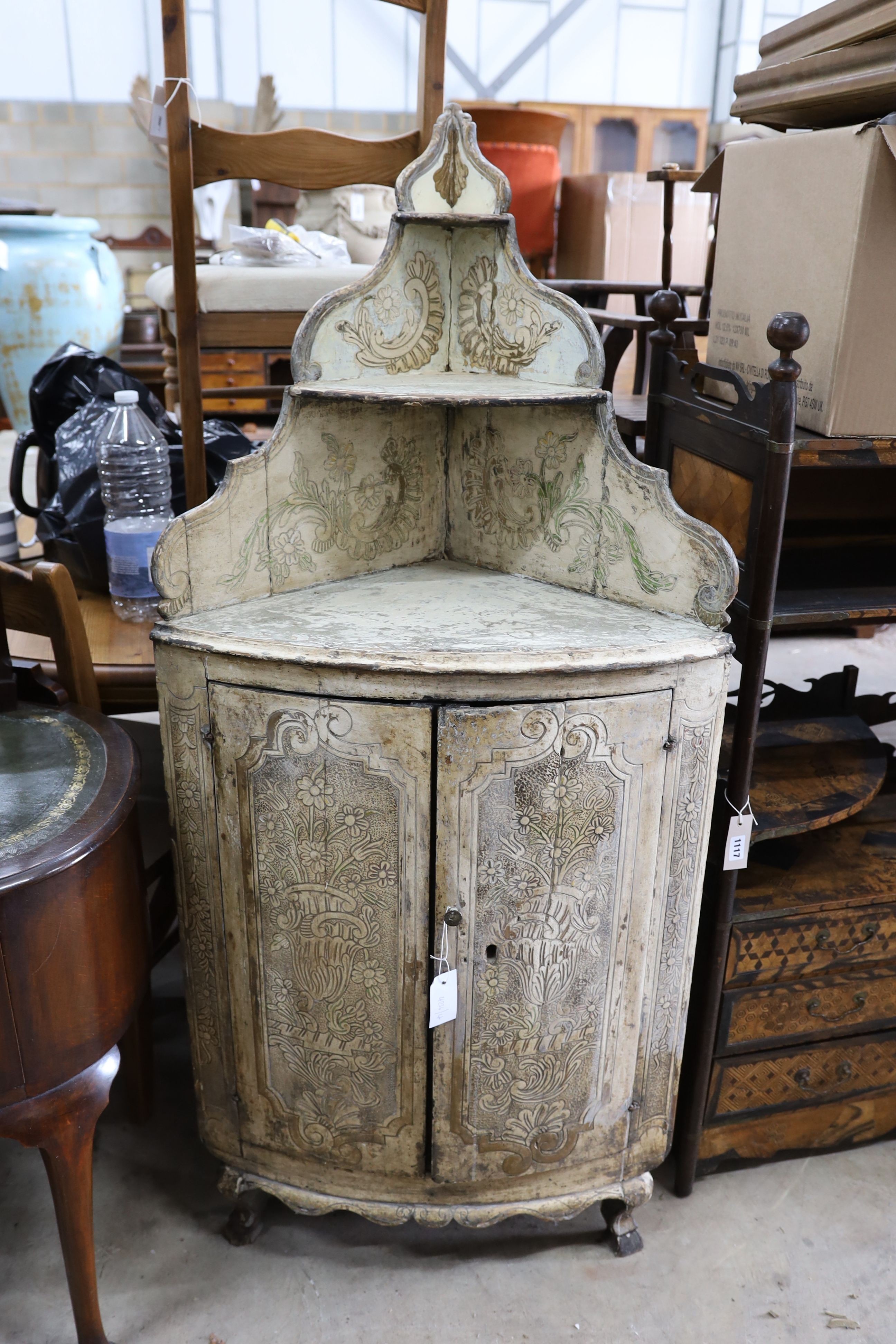 An 18th century Italian painted carved pine bow front standing corner cabinet, width 64cm, depth 38cm, height 145cm